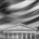 An image of the Supreme Court building against the backdrop of a blurred American flag.