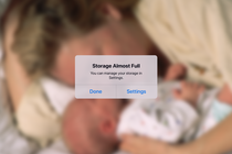 A "storage almost full" notification appears over a photo of a parent and their baby