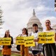 Members of Sunrise Movement stand in front of the Capitol during a press conference.