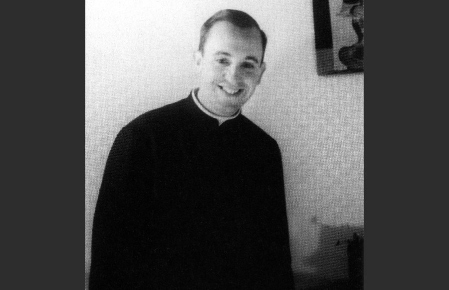 A black-and-white photo of a younger Pope Francis, then a priest named Jorge Mario Bergoglio