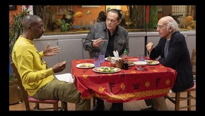Larry David eating at a restaurant with two friends