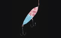 fishing lure made from packaging with two double hooks, dangling from string