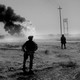 An image of U.S. soldiers standing guard over an Iraqi oilfield, 2003