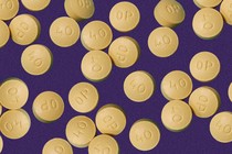 OxyContin pills against a purple background