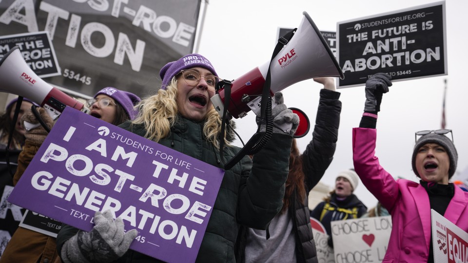 Protesters at the March for Life, with one holding an "I am the post-Roe generation" sign