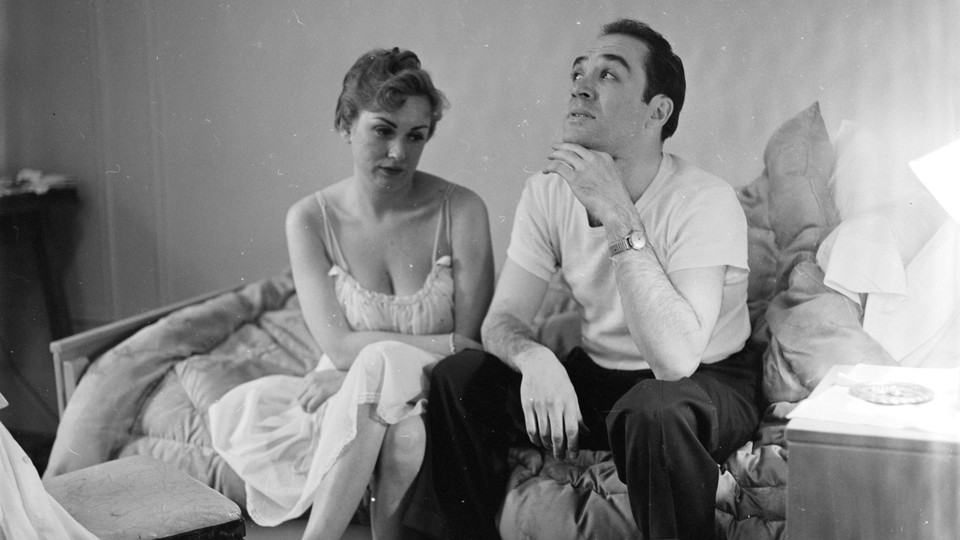 A black-and-white photo of a couple looking unhappy