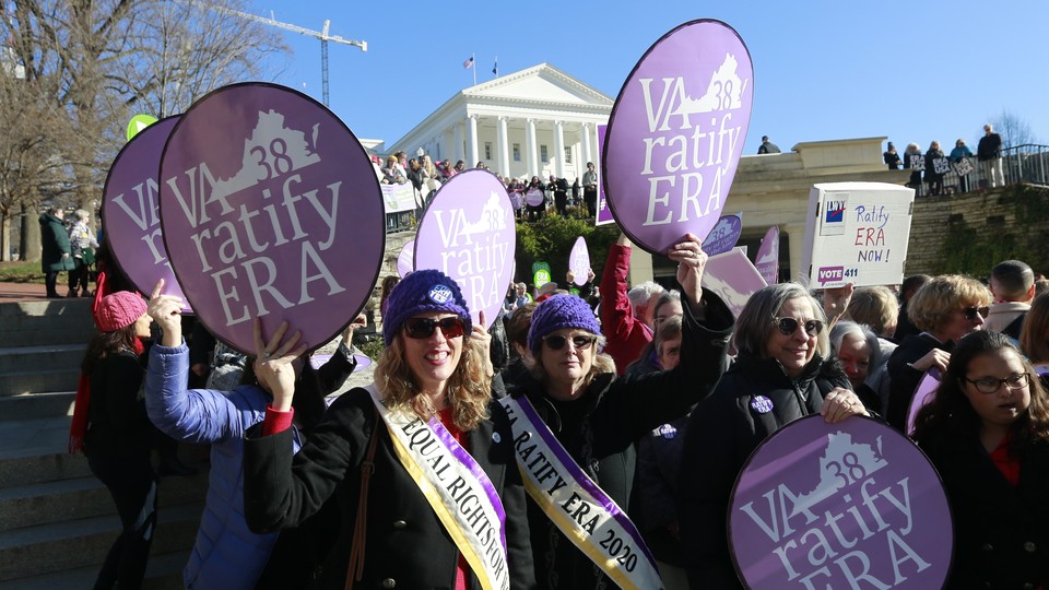 Equal Rights Amendment supporters holding up "VA 38 ratify ERA" signs