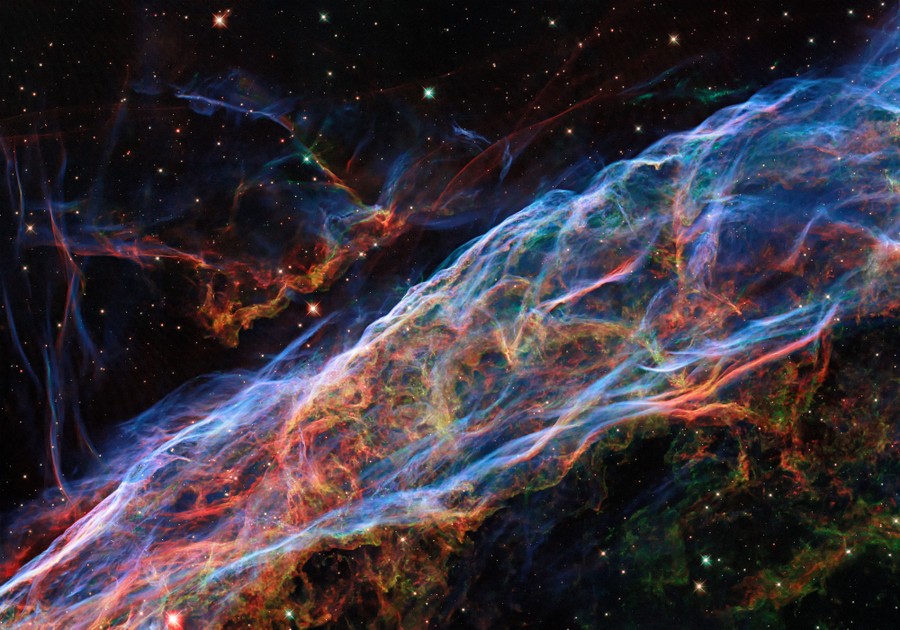 Colorful swirls of gas hang in the blackness of space.