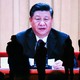 A large screen showing Xi Jinping
