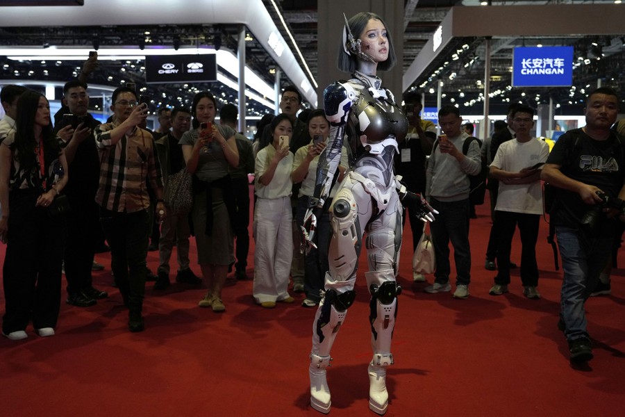 A person, dressed as a humanoid robot, posing for photographs