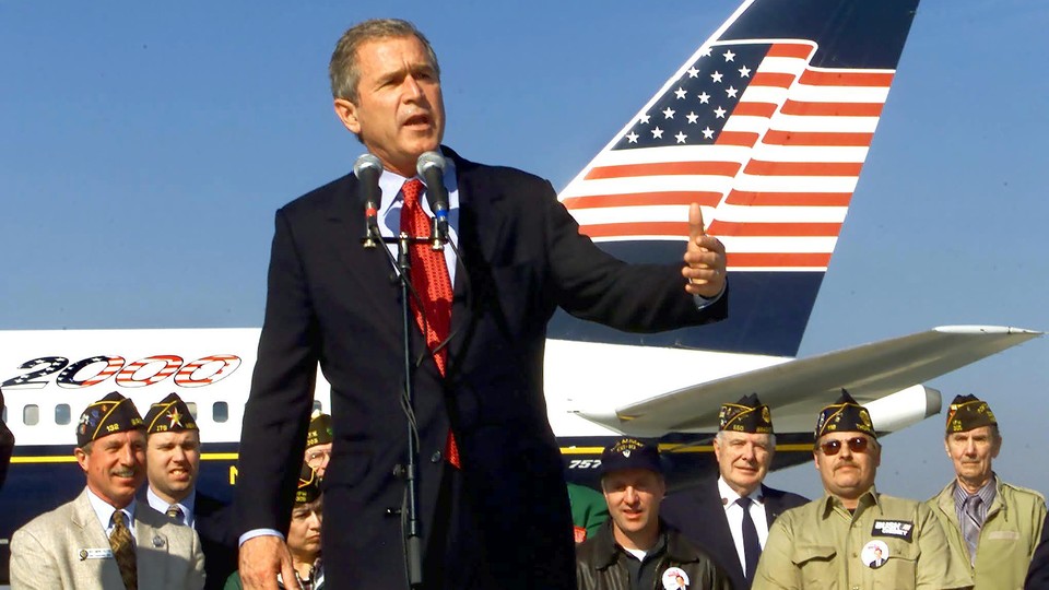 George W. Bush, standing in front of his campaign airplane, addresses supporters during a campaign rally in October 2000.