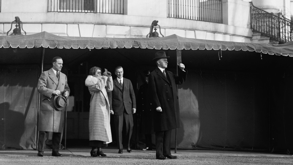 President Calvin Coolidge watches a total solar eclipse from the White House lawn on January 24, 1925.