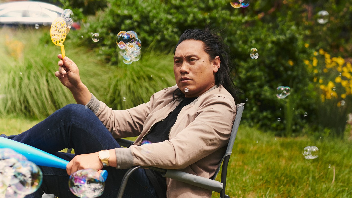 Jon Chu in a yard chair with bubbles