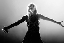 Taylor Swift in black and white with arms outstretched