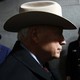 A side profile angle of Dick Cheney wearing a cowboy hat, which shades the top half of his face