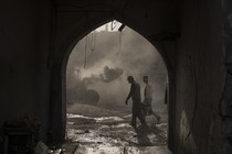 Construction workers remove debris from destroyed shops in Mosul in November 2017.