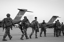 Soldiers of the 82nd Airborne Division walk to board a plane in Fort Bragg, North Carolina, on February 14, 2021 as they are deployed to Europe.