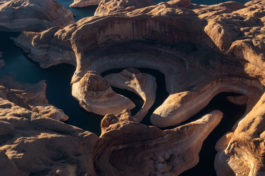An aerial view of the twisting path of a river through a desert canyon.
