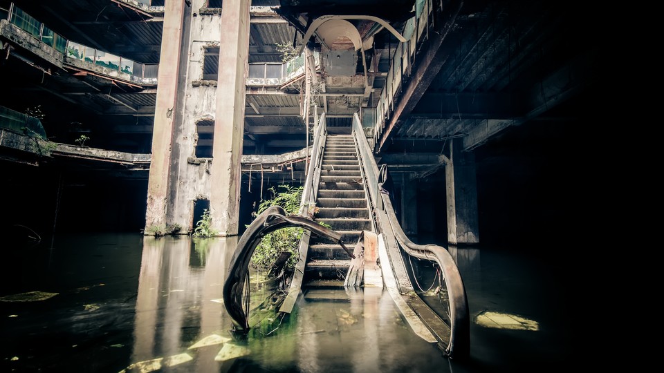 Damaged escalators in an abandoned shopping mall sunken by rain flood waters