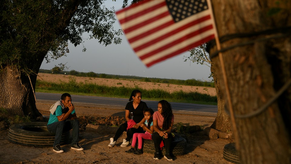 Central American asylum seekers wait to be transported to a processing facility after turning themselves in to the U.S. Border Patrol in Los Ebanos, Texas.