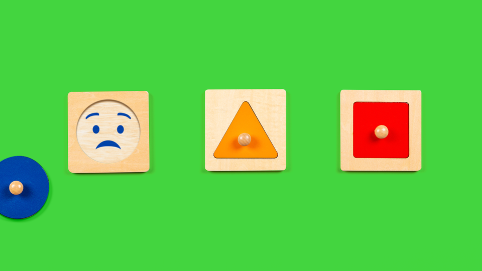 An illustration of wooden children's toys, one of which has a worried emoji face on it
