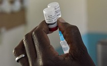 A health worker prepares a malaria vaccination.