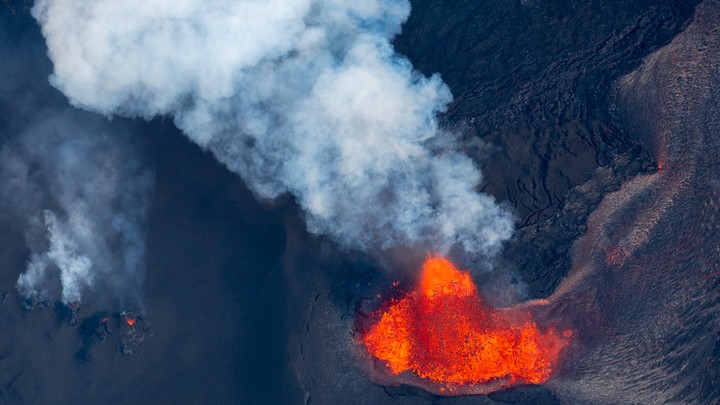 A volcano spewing red and orange lava