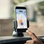 A hand pointing to a smartphone with Uber's app open