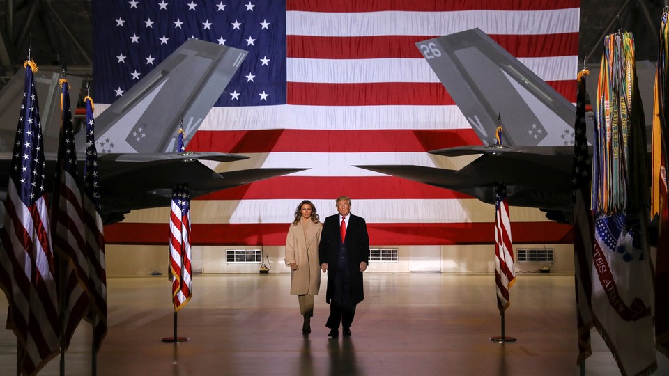 Donald and Melania Trump at Joint Base Andrews. They are flanked by Air Force planes on their left and right.