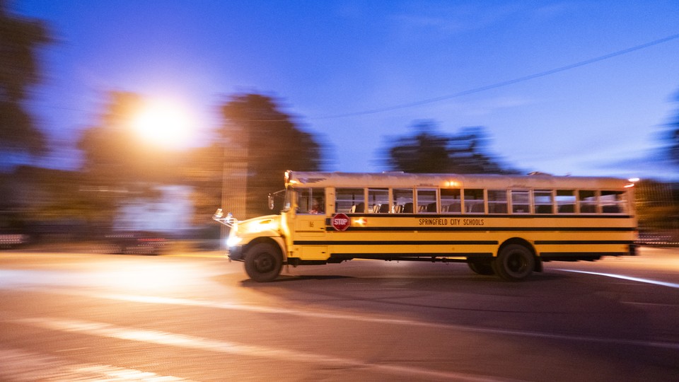 A school bus picks up children in the early morning