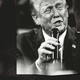 A black-and-white photo-illustration of Donald Trump holding a microphone up to his mouth