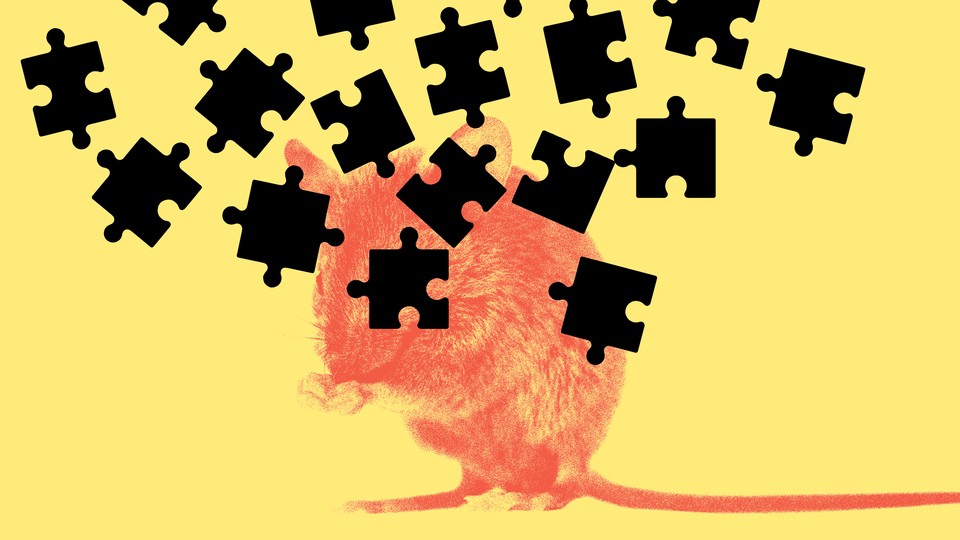 A red mouse on a yellow background with black puzzle pieces raining down