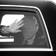 Trump waving from a car