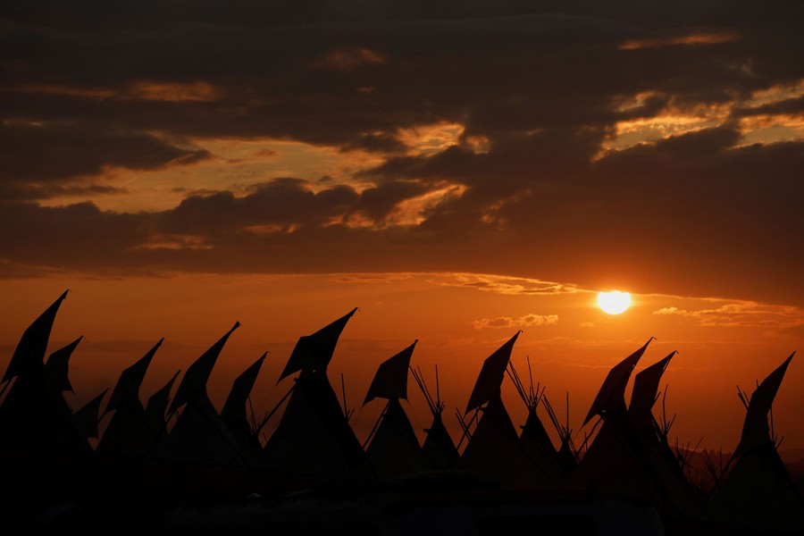 A view of a sunset scene behind a group of tents