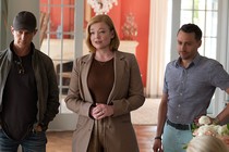 Three characters from HBO's "Succession" all dressed in "stealth wealth" clothing, including a several-hundred-dollar black wool baseball cap on one of them.