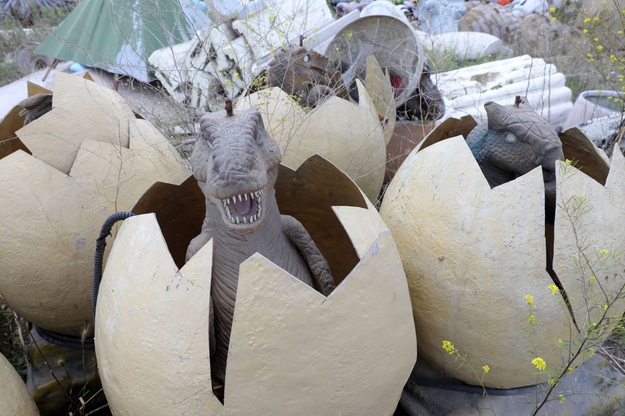Several abandoned dinosaur hatchling statues