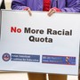 A sign says "No More Racial Quota"