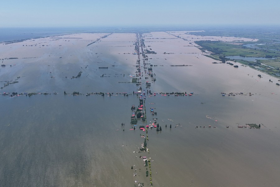 An aerial view of a broad stretch of flooded farmland