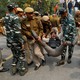 Police detain activists during a protest in Delhi.
