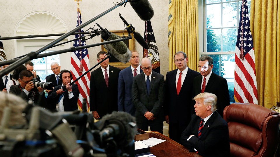 President Trump addresses journalists in the Oval Office.