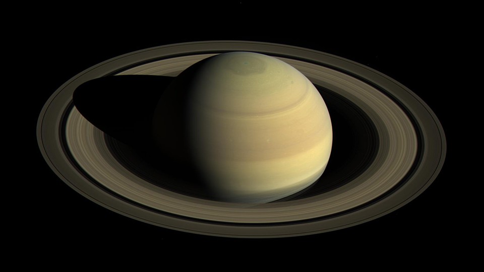 A picture of Saturn and its rings hovering in the darkness of space