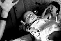 a baby, a hand, an overwhelmed woman