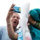 Tom Steyer makes a funny face while taking a selfie with a woman at the Iowa State Fair.
