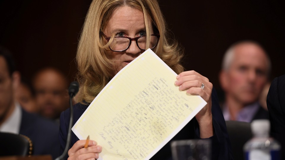 Christine Blasey Ford holding a piece of paper