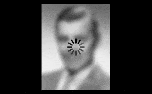 Clark Gable's face, mostly blurred out, with a spinning wait cursor overlaid