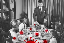 A black-and-white photo of a family sitting down for a holiday dinner, overlaid with red coronavirus particles