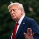 Donald Trump holds up his hand as he walks away