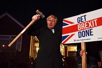 Boris Johnson with a sign reading "Get Brexit Done."