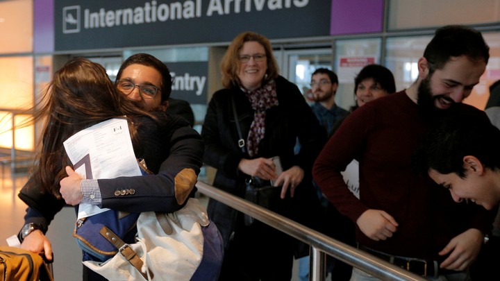 Behnam Partopour, a student from Iran, is greeted by his sister Bahar at Logan Airport after he cleared U.S. customs and immigration on an F1 student visa in Boston.
