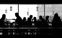 Silhouettes of people sitting in a restaurant
